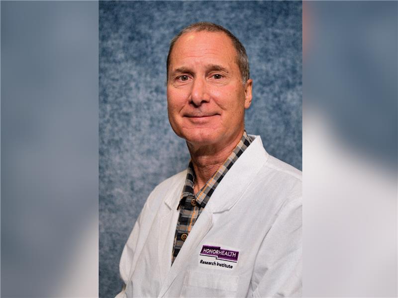 A man in a white lab coat with a 