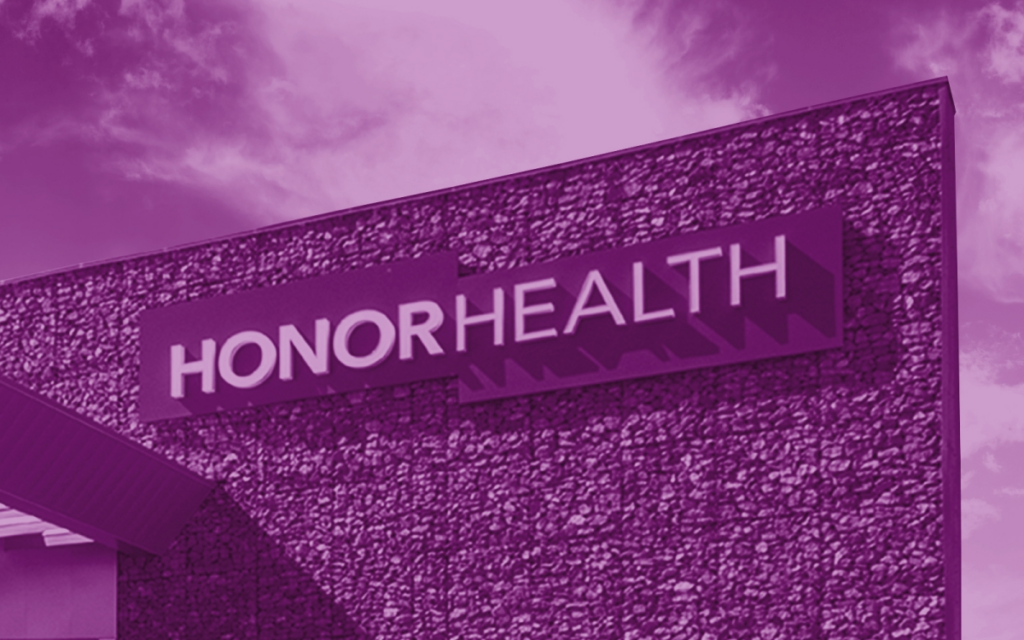 A building with a stone facade displays a sign that reads 