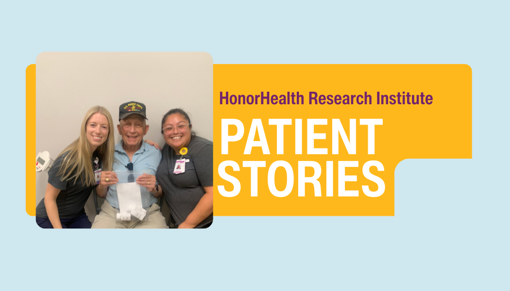 An elderly man sits between two smiling healthcare workers in front of a wall that reads "HonorHealth Research Institute Patient Stories.