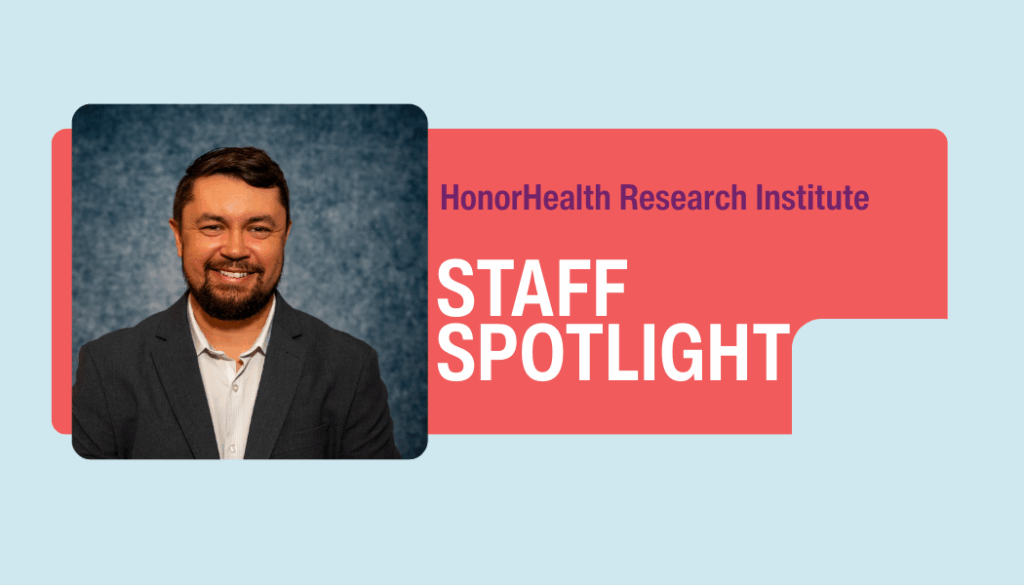 A man in a suit jacket smiles at the camera next to text reading 